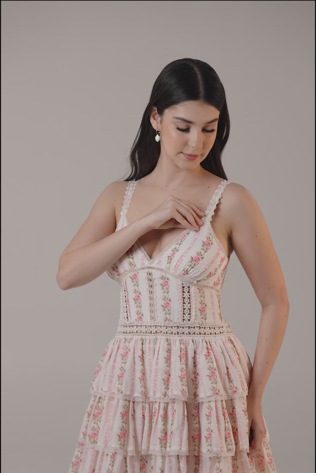 Pink floral tiered mini dress with lace trim and fitted bodice