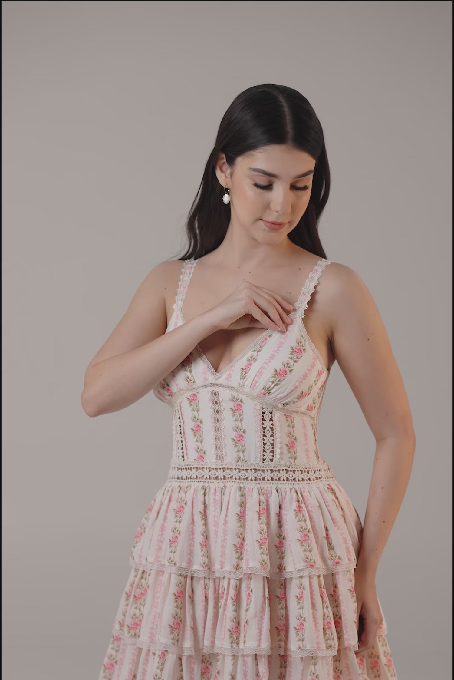 Pink floral tiered mini dress with lace trim and fitted bodice