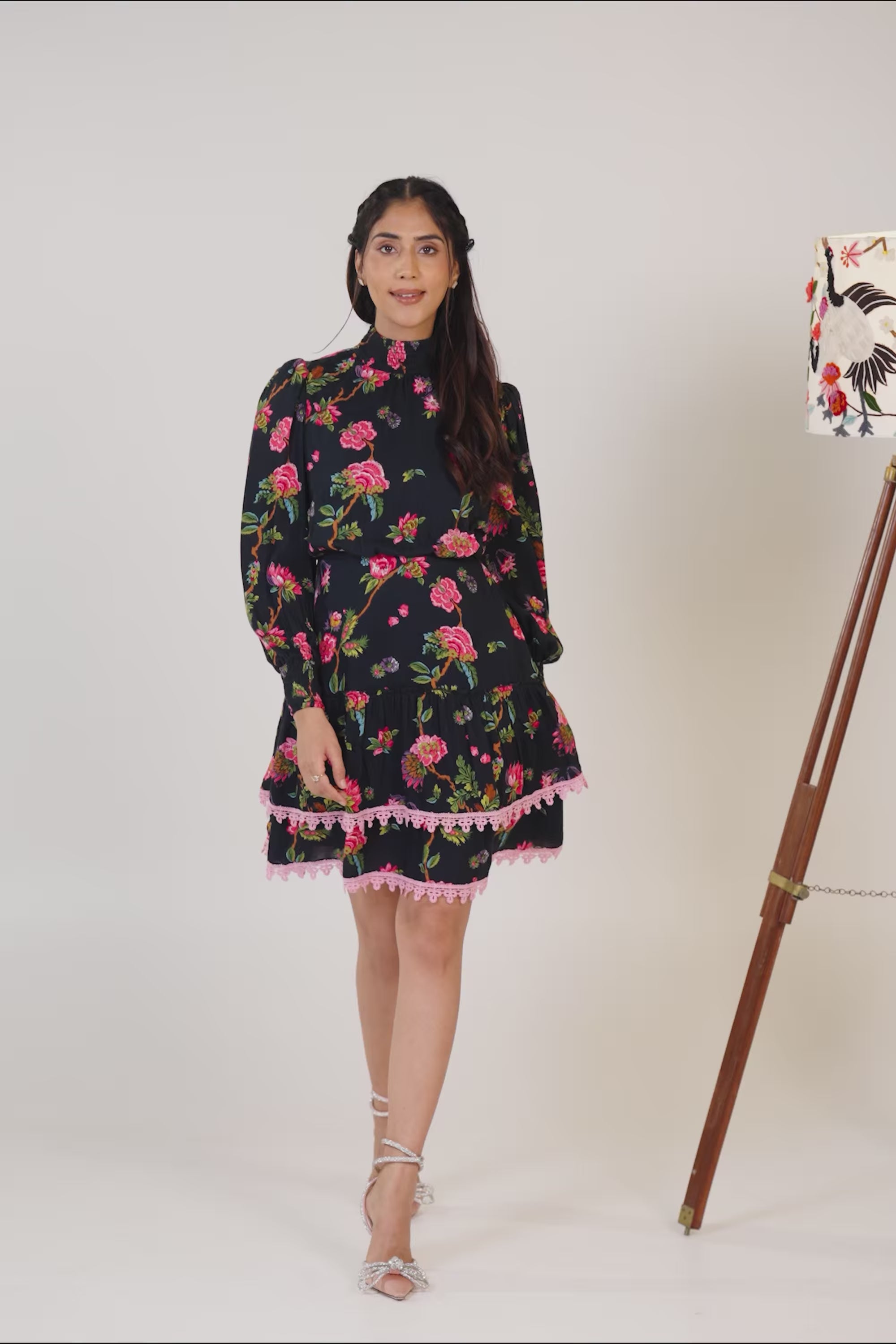 Black floral lace-trim mini dress with long sleeves.