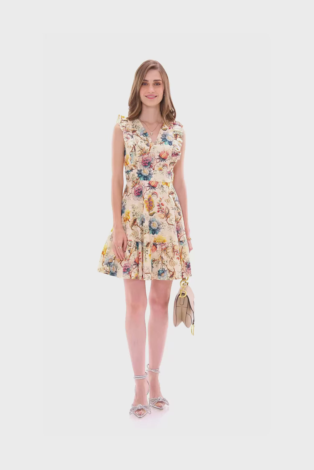 Cream floral ruffle mini dress with v-neck and layered hem.