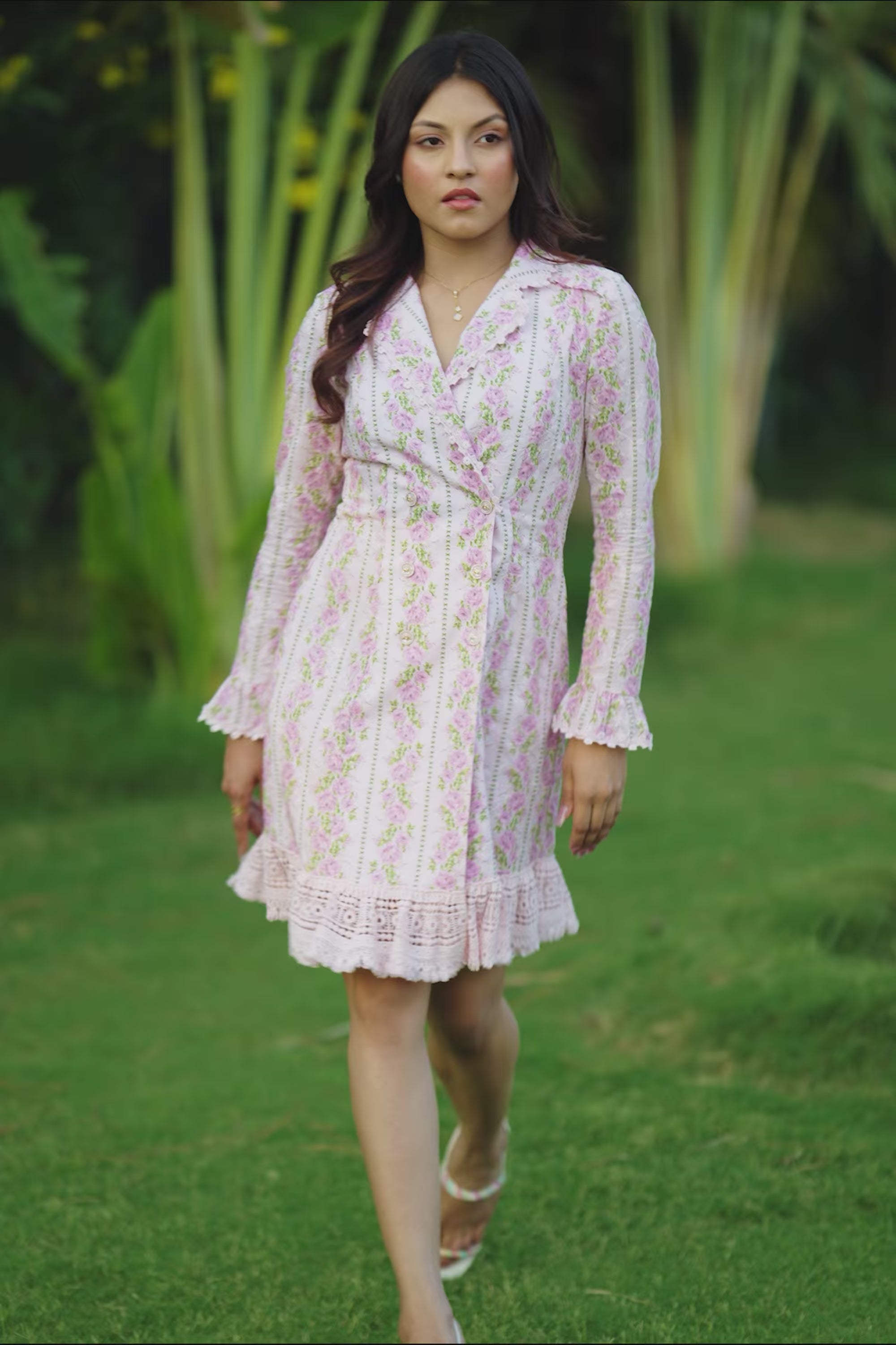 White mini dress with pink floral print and lace trim.