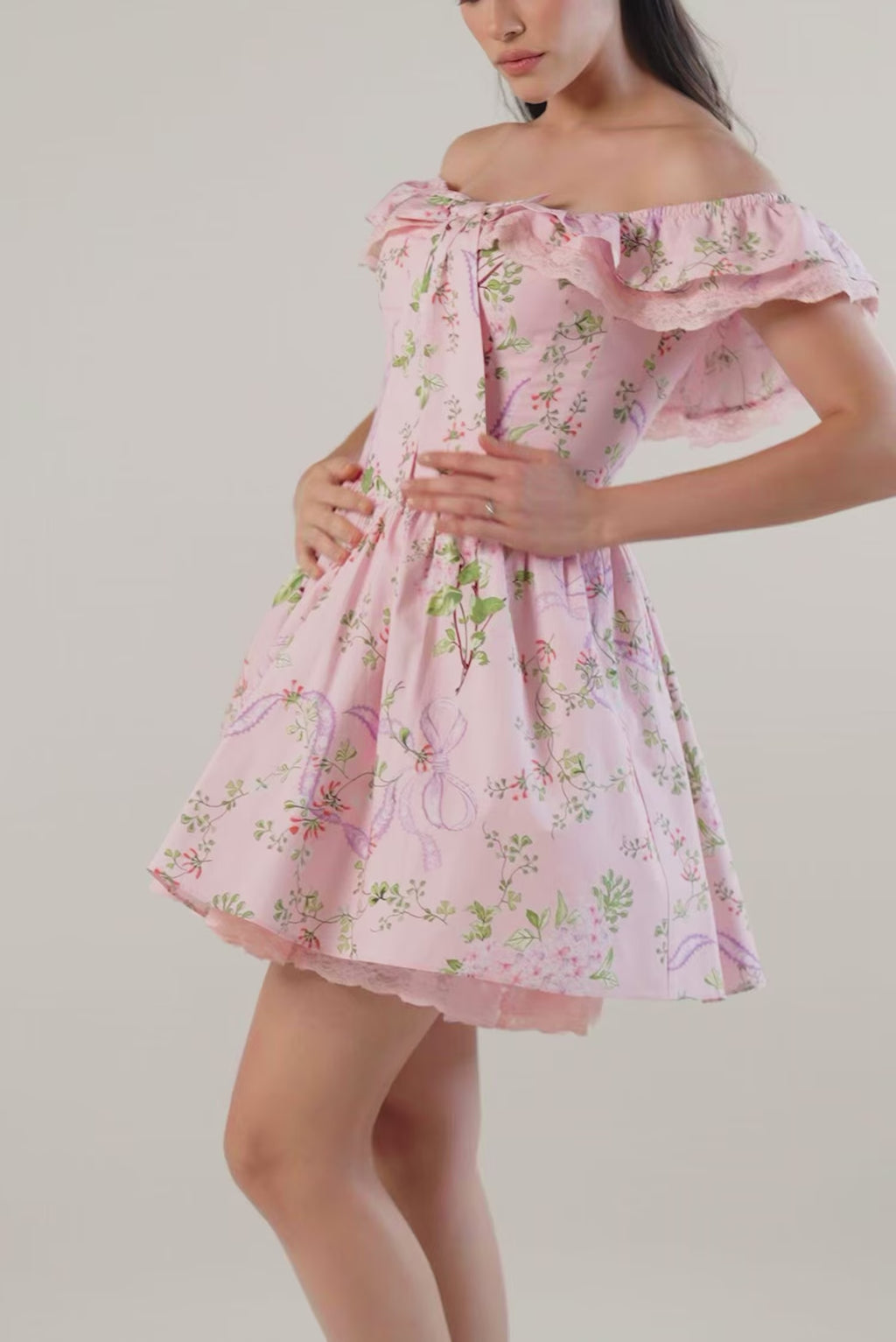 Women’s pink floral off-shoulder mini dress with ruffled lace neckline, statement bow and pockets