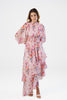 Woman in pink floral high neck layered maxi dress with long sleeves