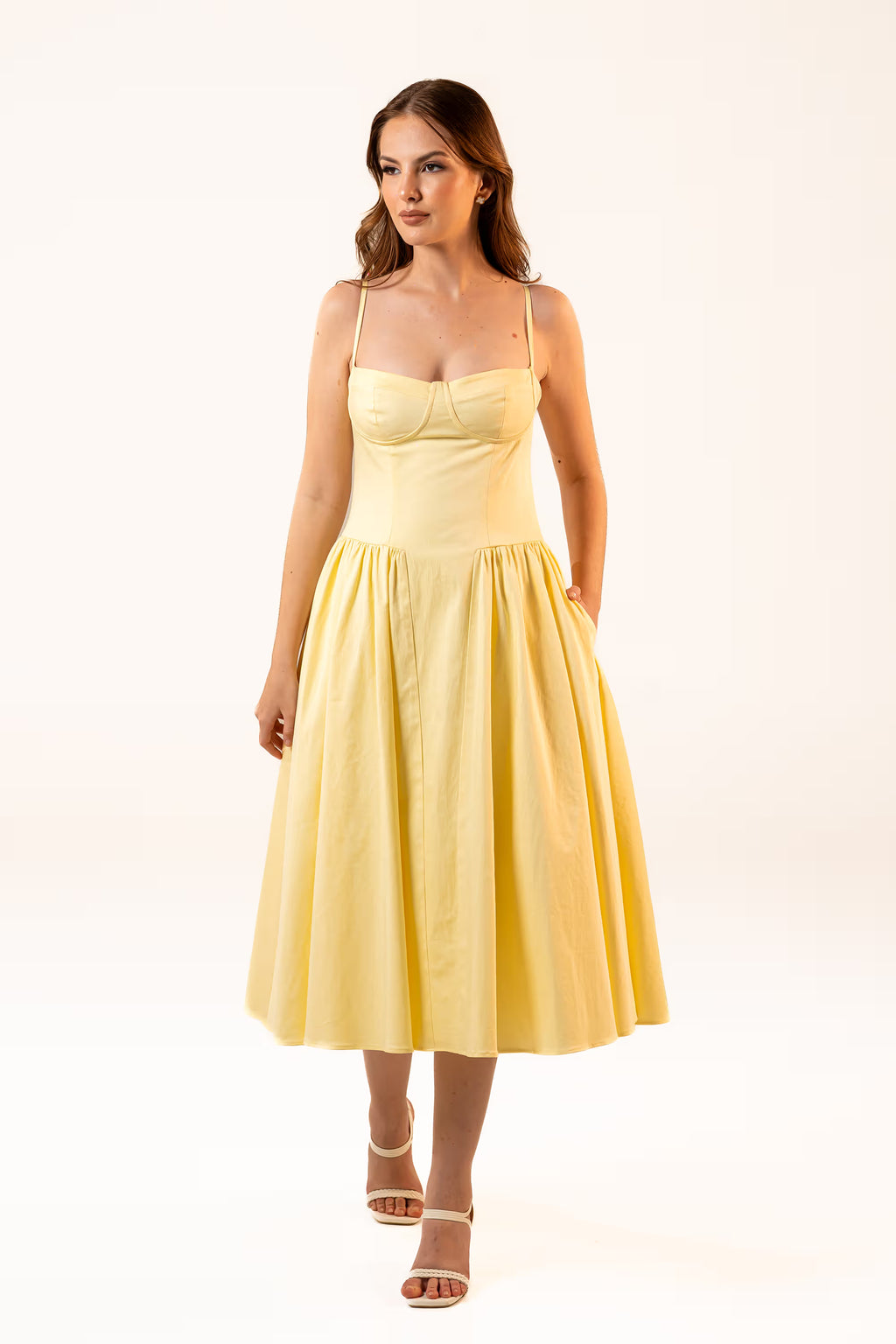 Woman in yellow midi dress with spaghetti straps and fitted bodice