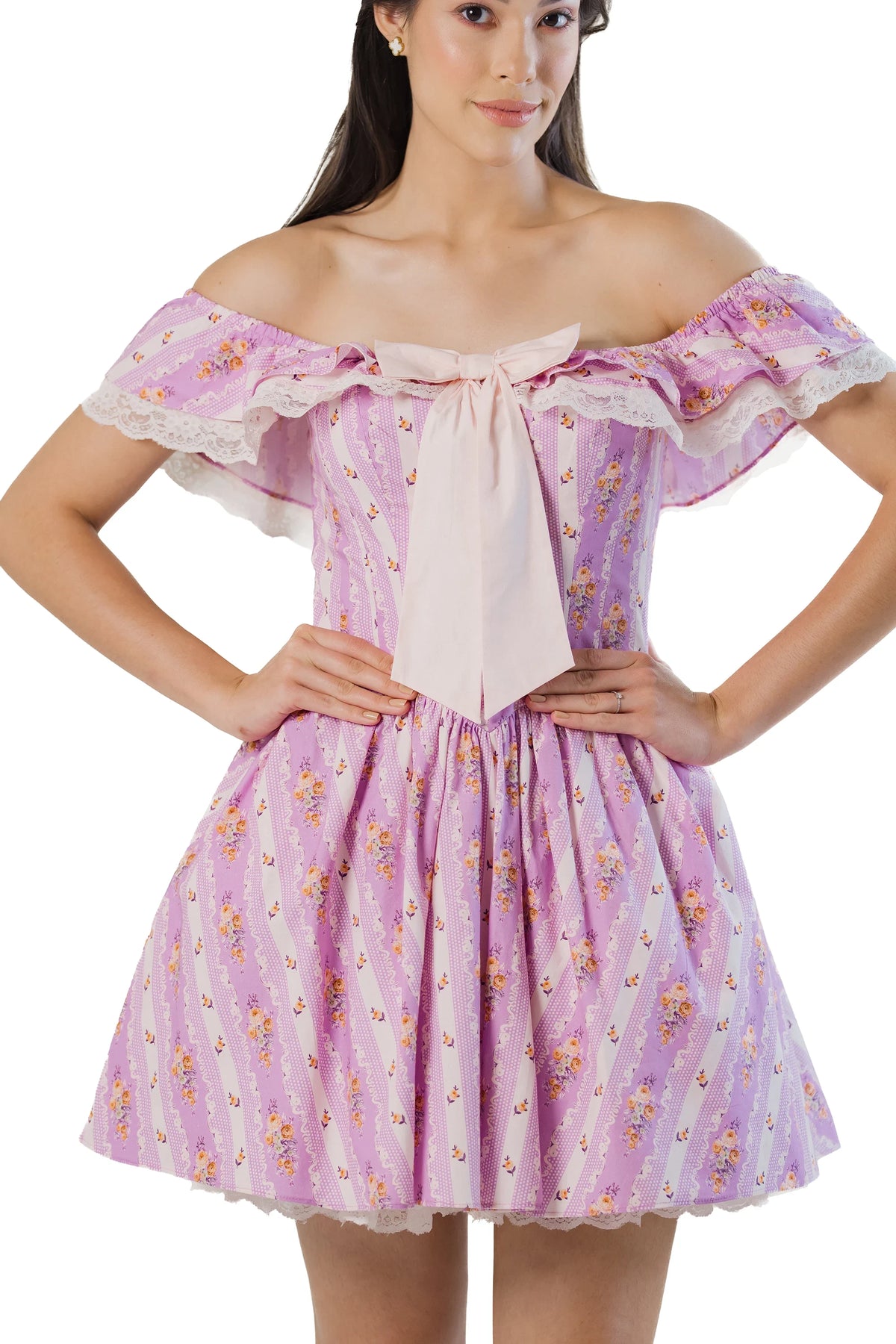 Close-up: oversized bow and lace-ruffle neckline on purple off-shoulder mini