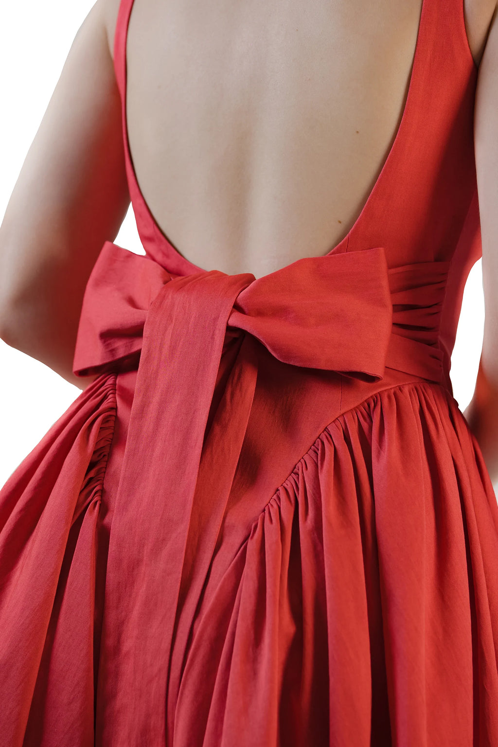 Back bow close-up on red open-back fit-and-flare mini dress