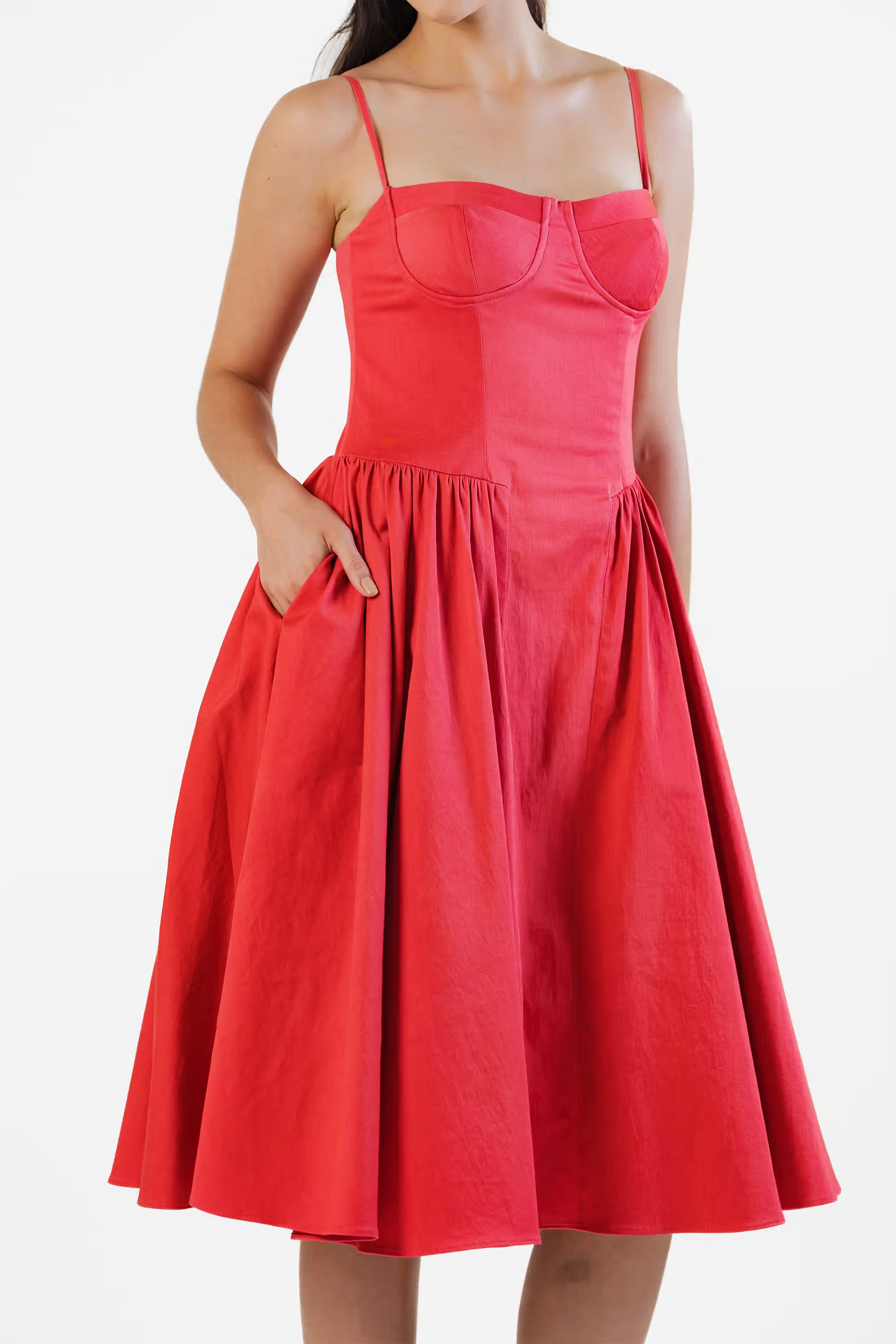 Red corset dress with practical side pockets and flared pleated skirt