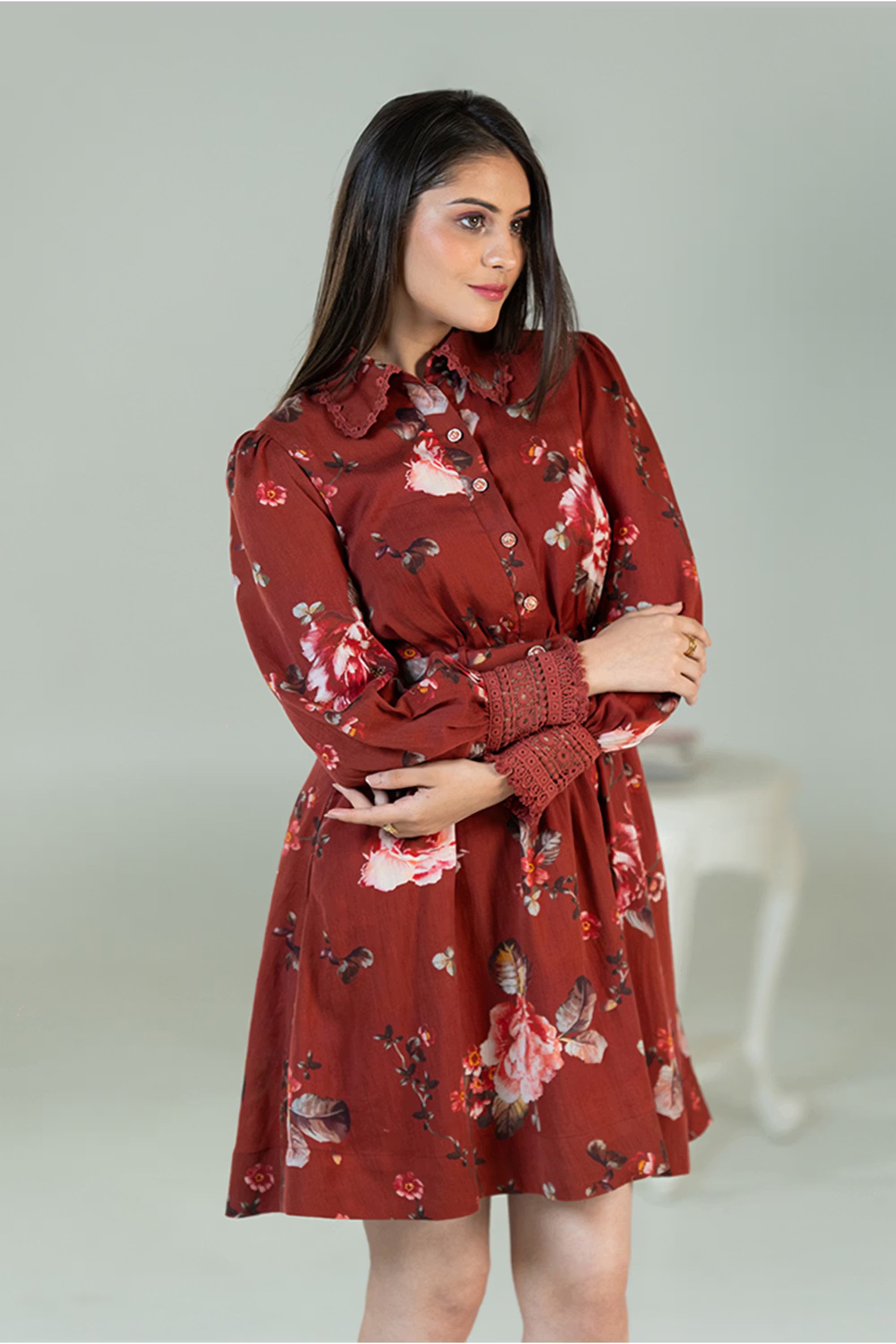 Women posing in rust red floral shirt dress with collared neckline and smocked cuffs