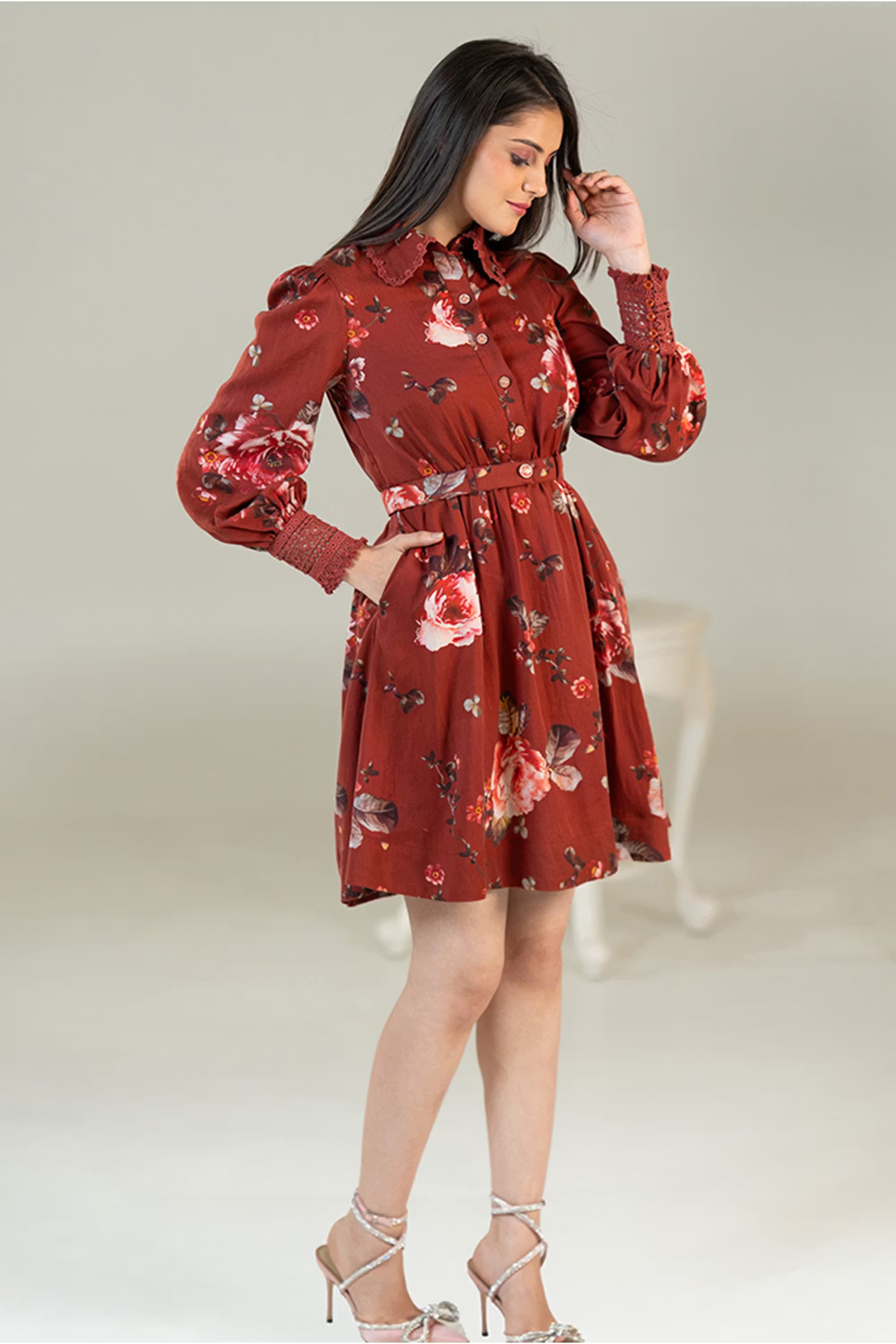 Side profile of rust red floral shirt dress with belted waist and puff sleeves