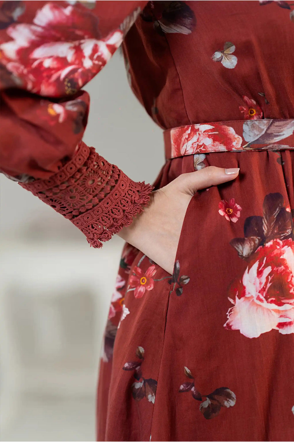 Sleeve and pocket closeup of rust red floral shirt dress