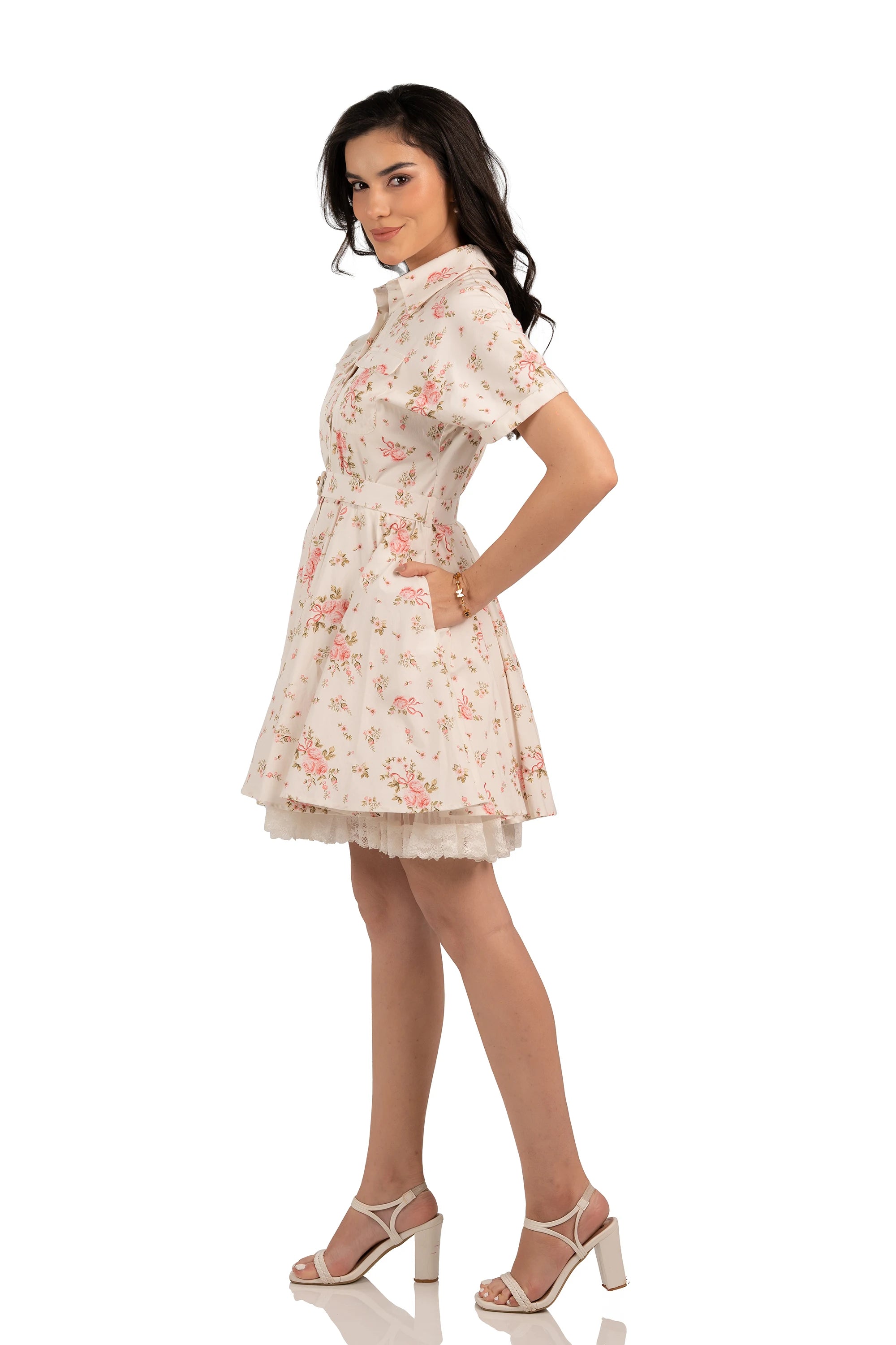 Side profile of cottagecore floral shirt dress with pink roses, belted waist, and lace hemline.