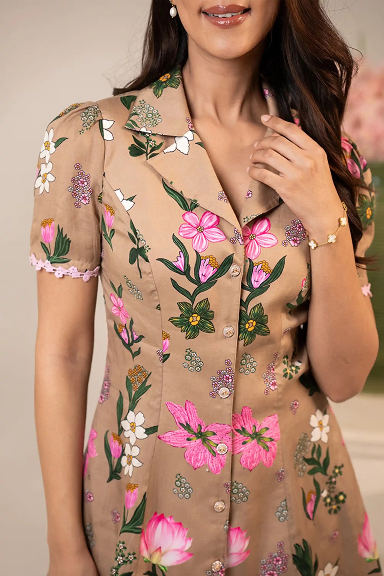 Closeup of bust detail on tan floral button-front short dress