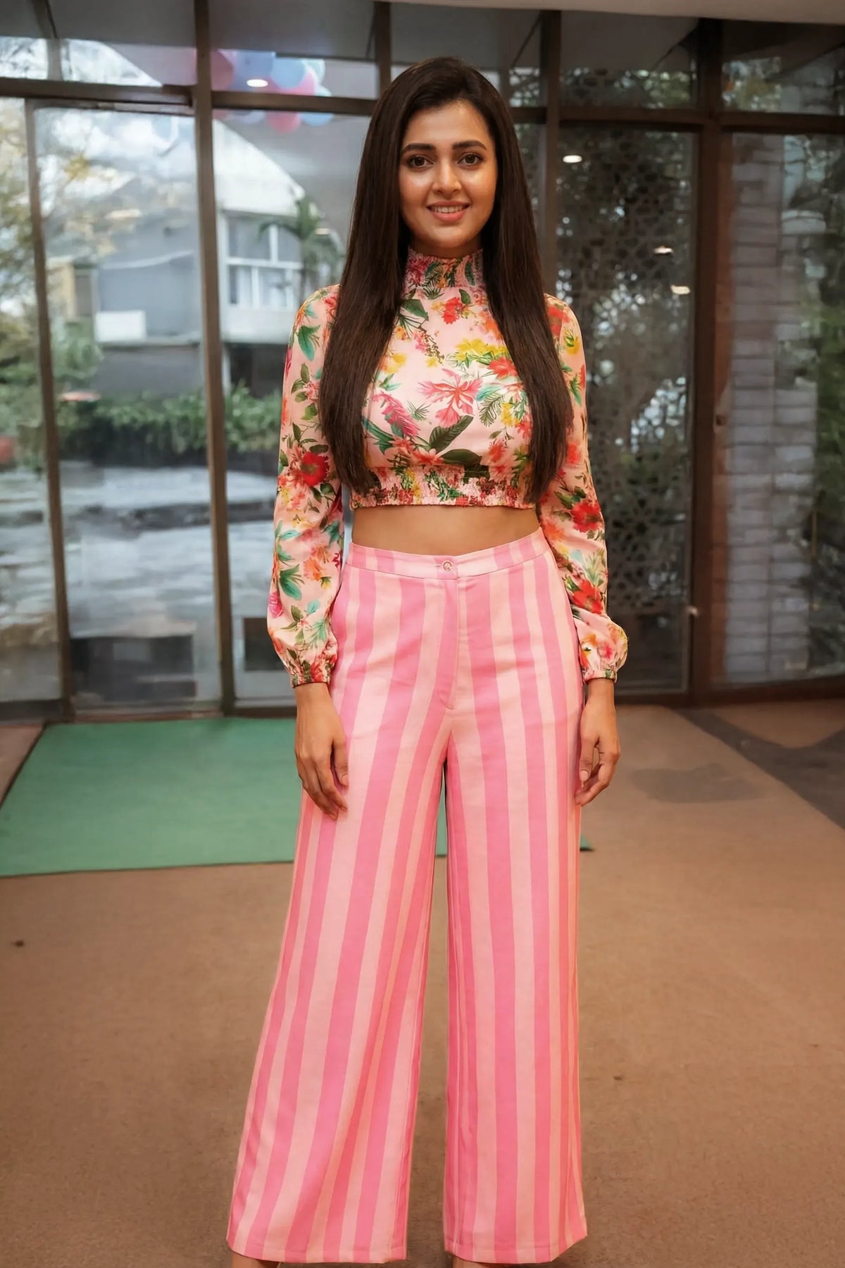 Tejasswi Prakash wearing floral high neck crop top with long sleeves and pink striped wide leg pants coord set at indoor event in India.
