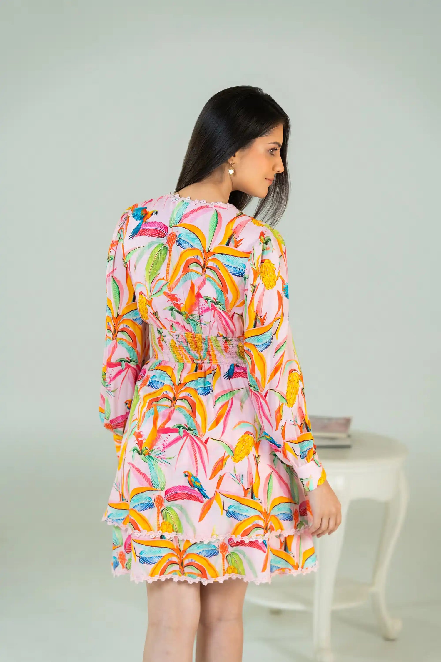 Back view of tropical parrot print pink short dress with fitted waist