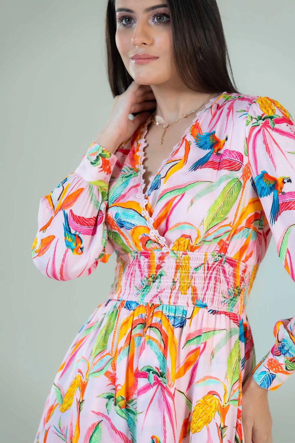 Closeup of tropical parrot print dress showing parrot and leaf design