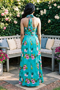 Full-length back view of turquoise floral halter maxi dress; organic cotton women's evening and occasion wear for women