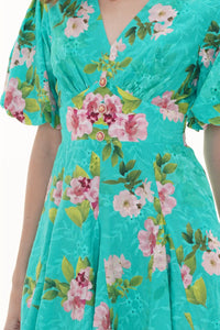 Close-up of Pretty Pixie turquoise floral lace-hem V-neck puff-sleeve mini dress, fabric detail