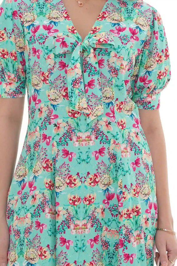 Close-up of Pretty Pixie turquoise floral V-neck puff-sleeve mini dress
