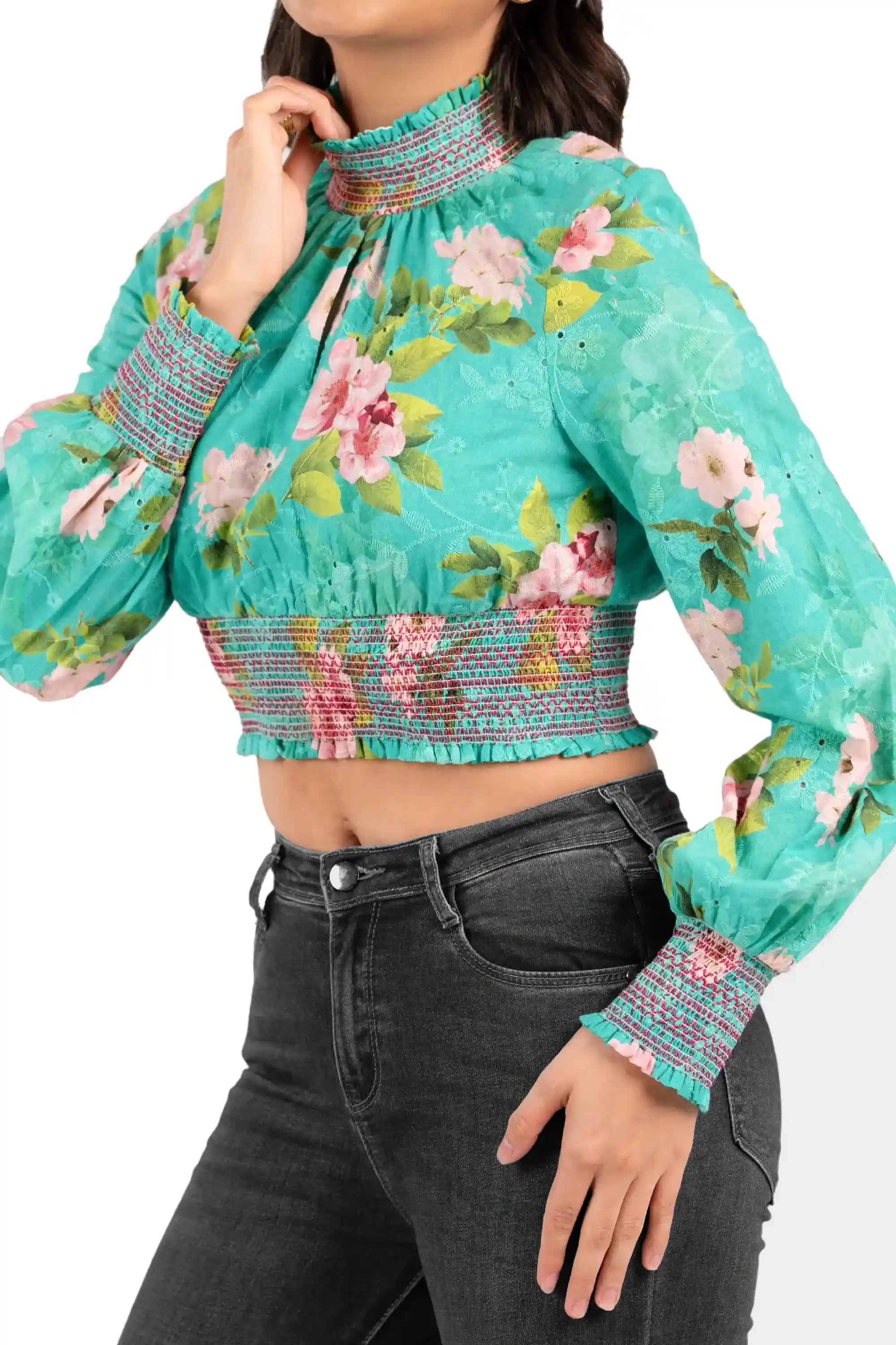 Close-up of high neck and smocked waist on turquoise floral long-sleeve crop top