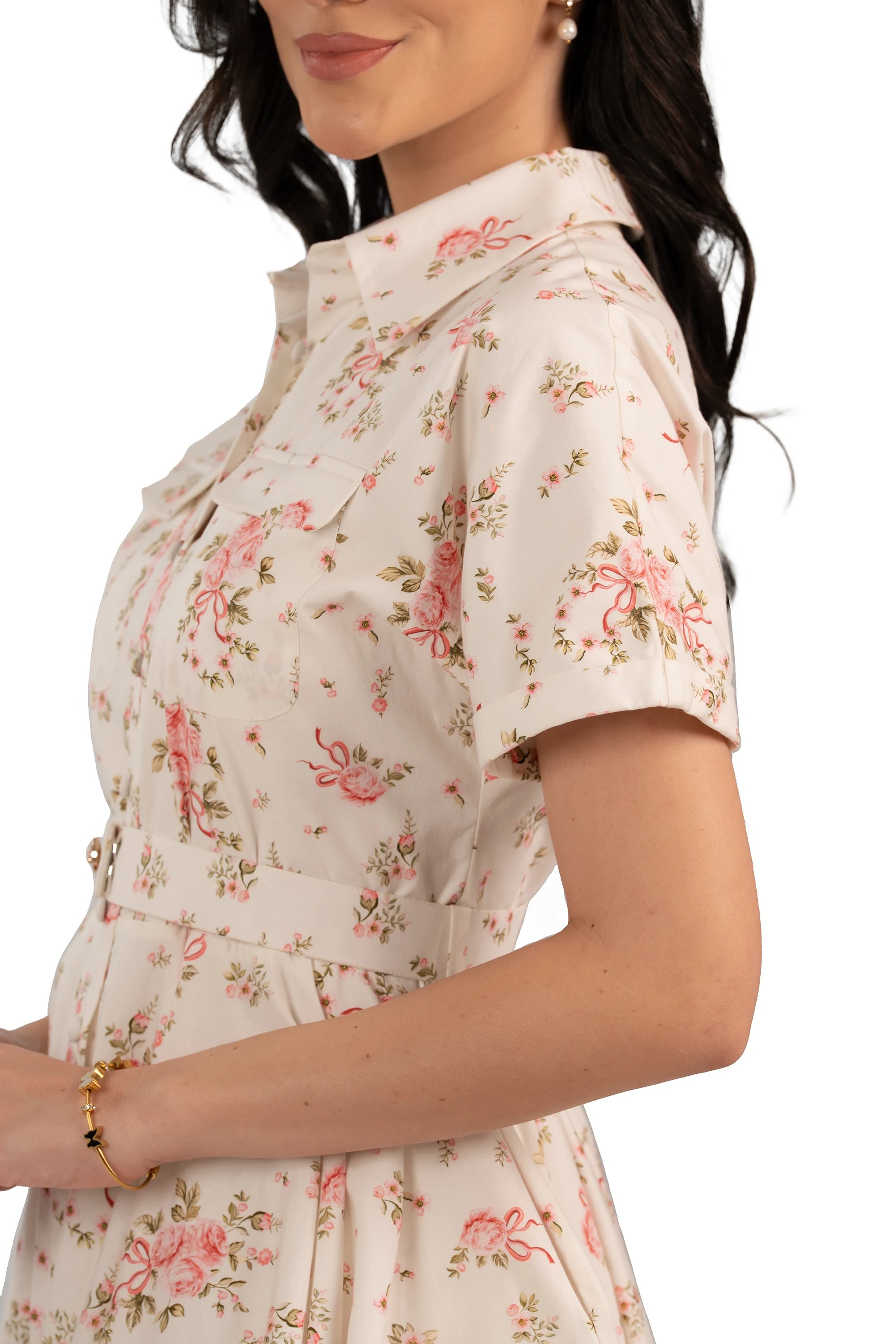 Vintage-inspired short sleeve floral shirt dress with pink rose print and waist belt, side front view.