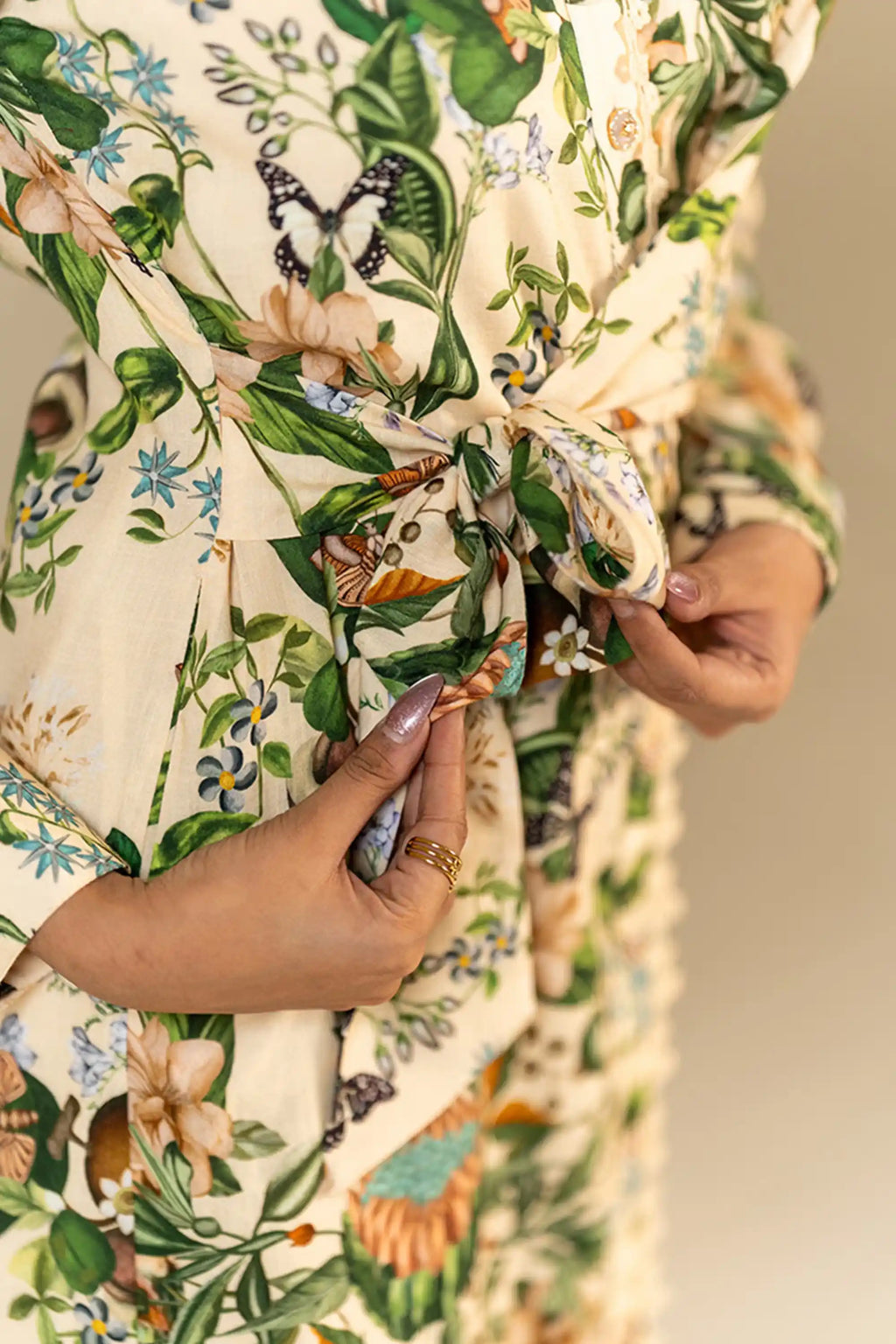 Waist tie detail of cream botanical floral shirt dress.
