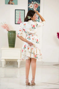 Back view of white floral ruffle mini dress with tiered skirt design