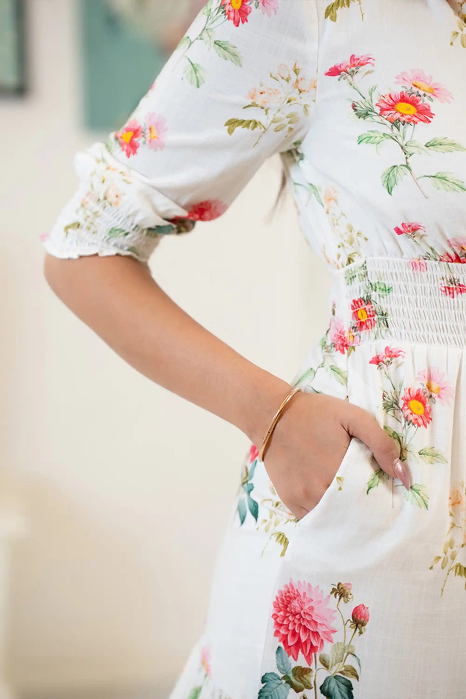 Pocket detail on white floral ruffle mini dress with red and pink floral prints