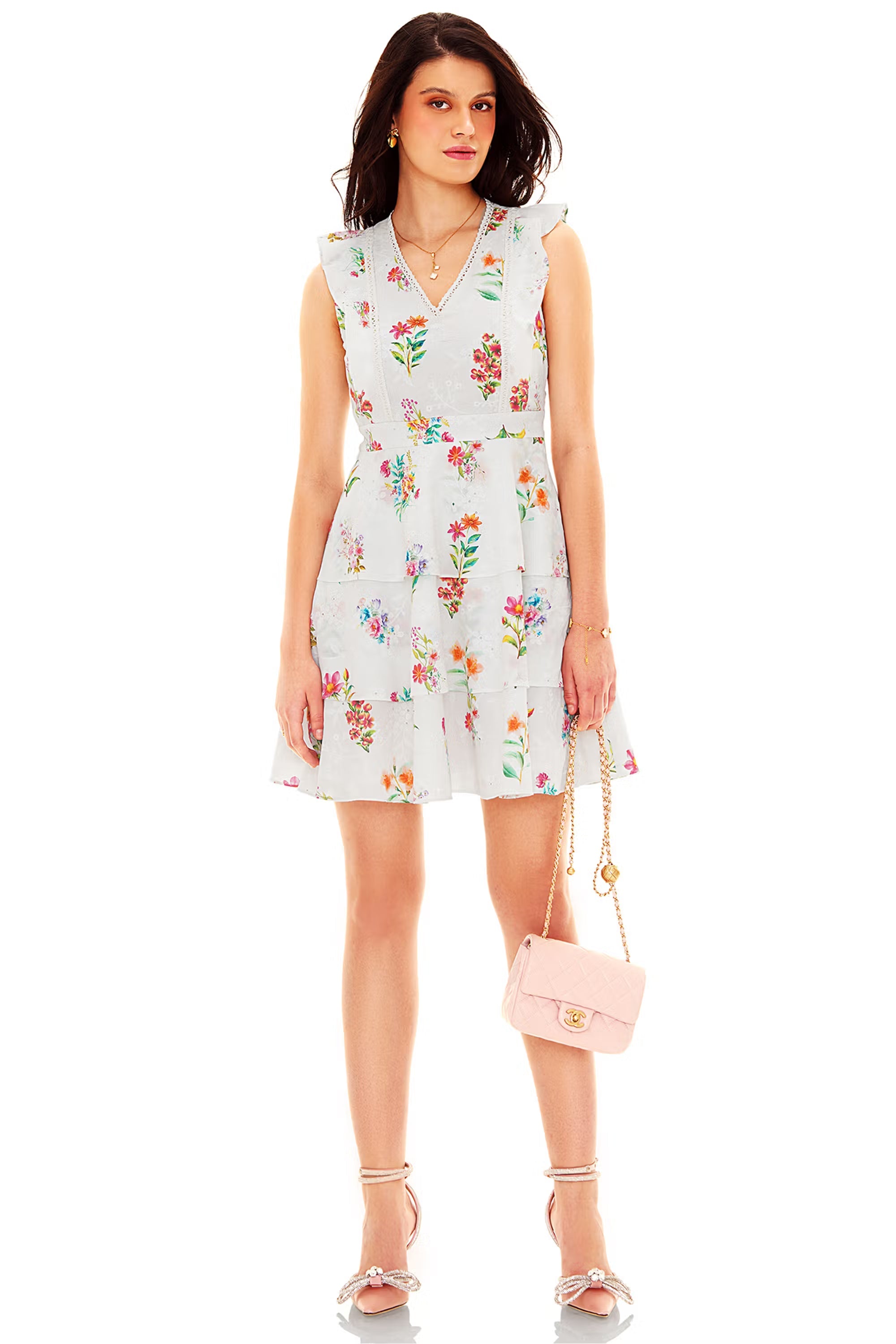 White floral sleeveless mini dress with V-neckline and layered ruffle hem, front view