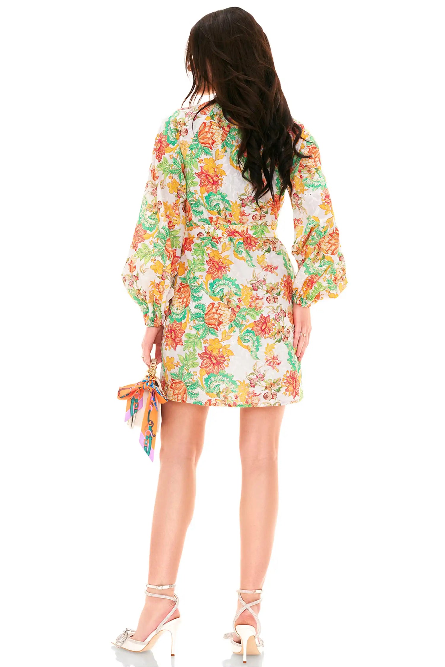 Back view of white belted floral mini dress with multicolor print and long sleeves