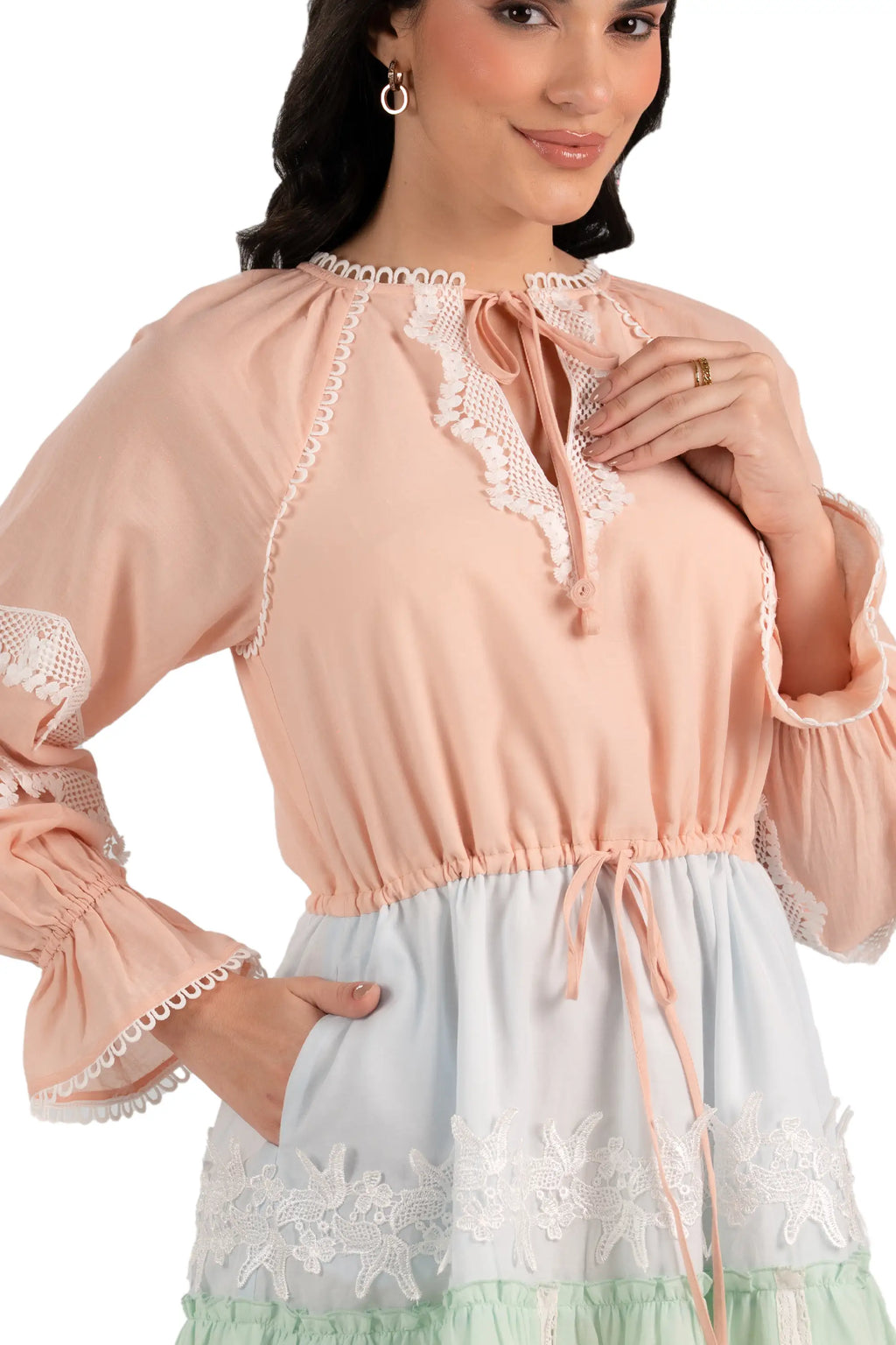 Close-up of lace bodice and drawstring waist on peach mint tiered mini dress