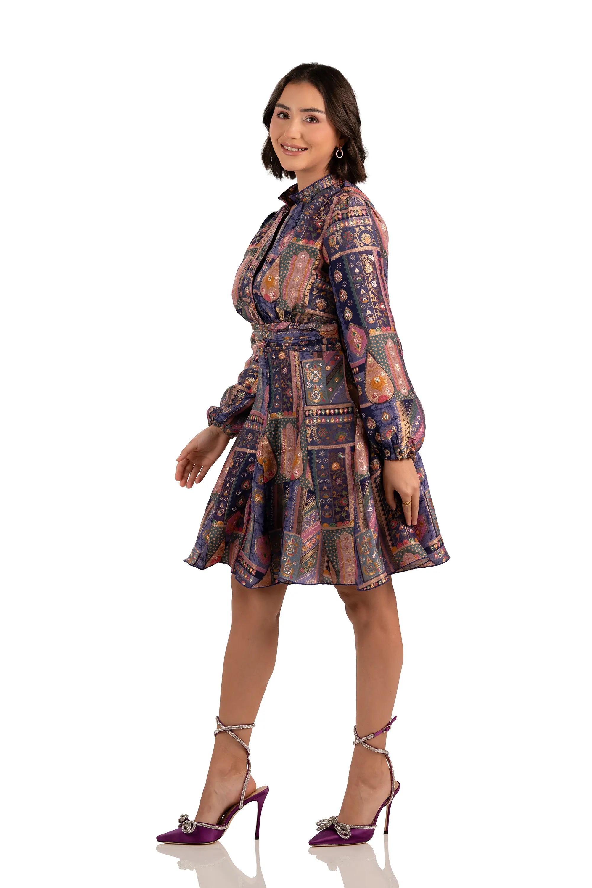 Model in navy boho patchwork mini dress, belted waist, long sleeves, side right view