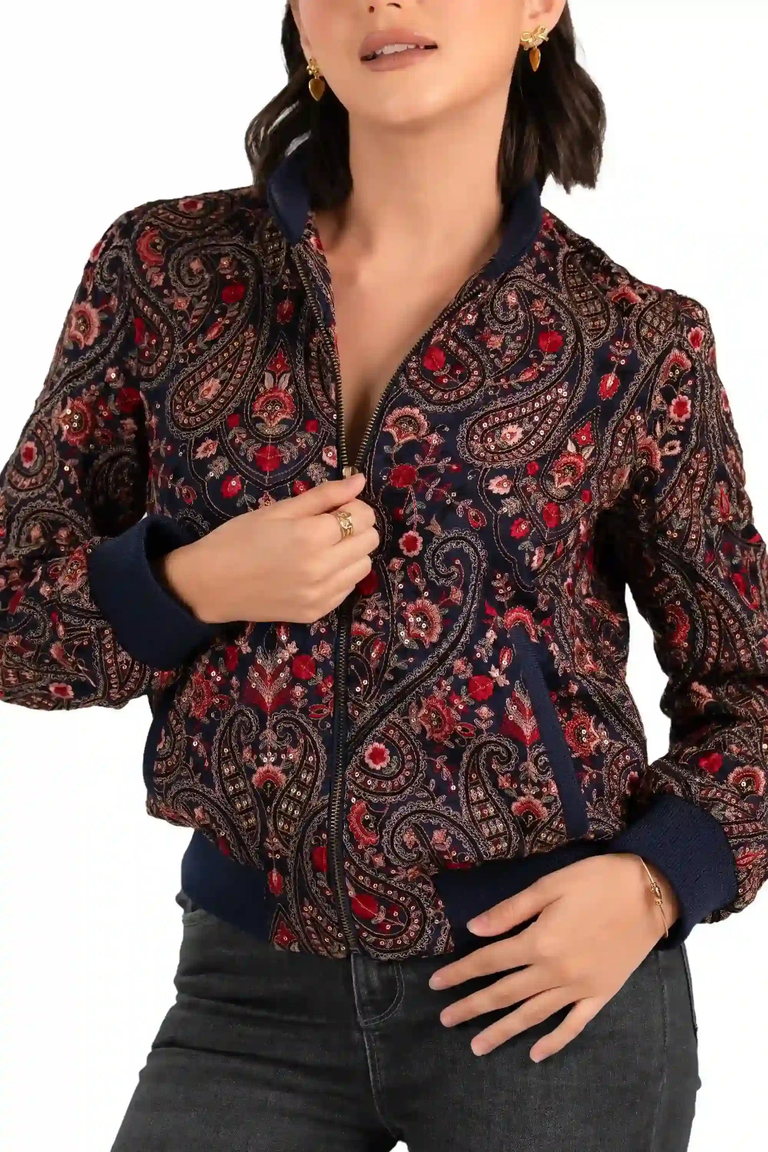 Close-up of navy paisley embroidery and zipper on bomber jacket