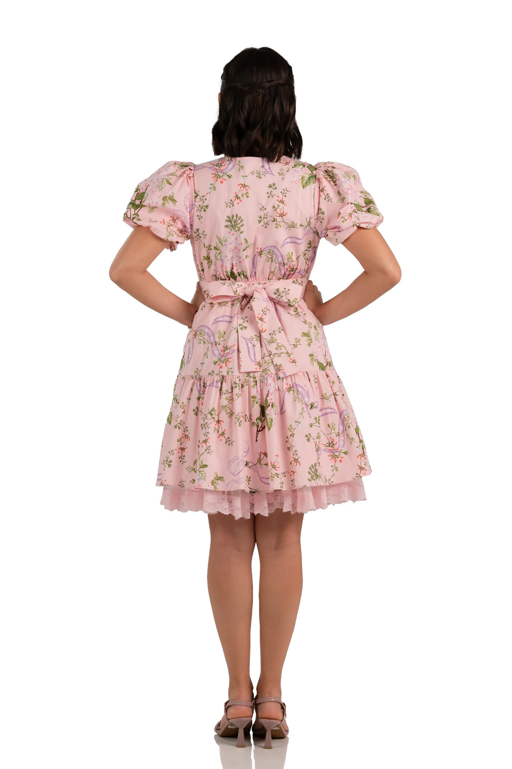 Back view of pink floral bow mini dress with lace hem and puff sleeves