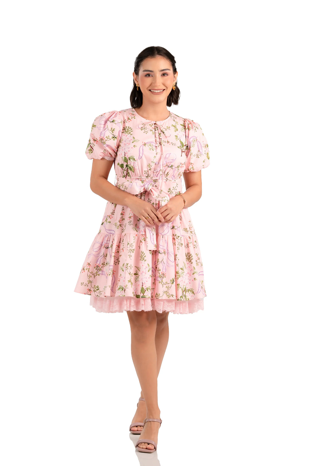 Front view of pink floral mini dress with puff sleeves, bow waist and lace hem