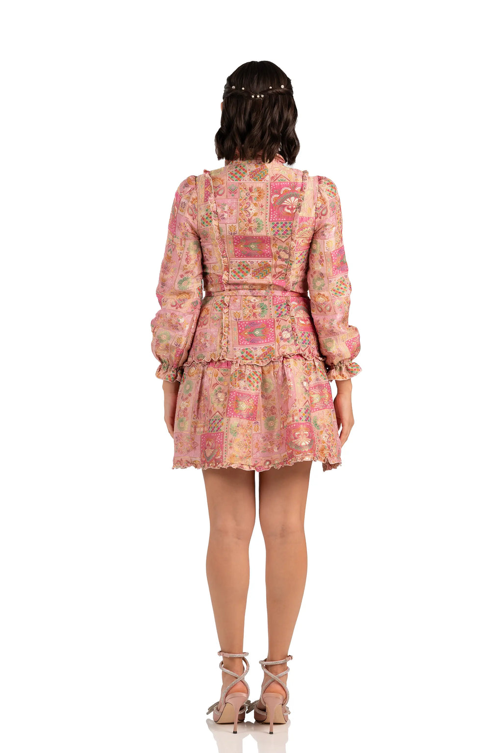 Back view of pink patchwork jacquard mini dress with ruffle hem and belt