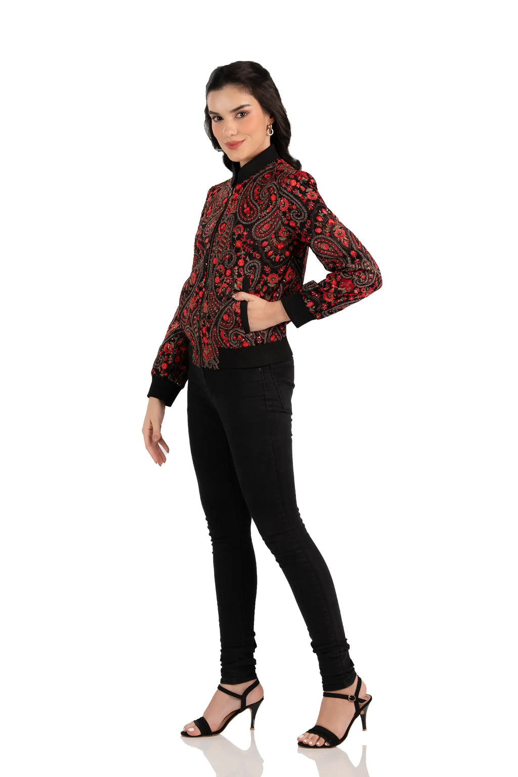 Angled side pose showing women’s black bomber jacket with red paisley pattern