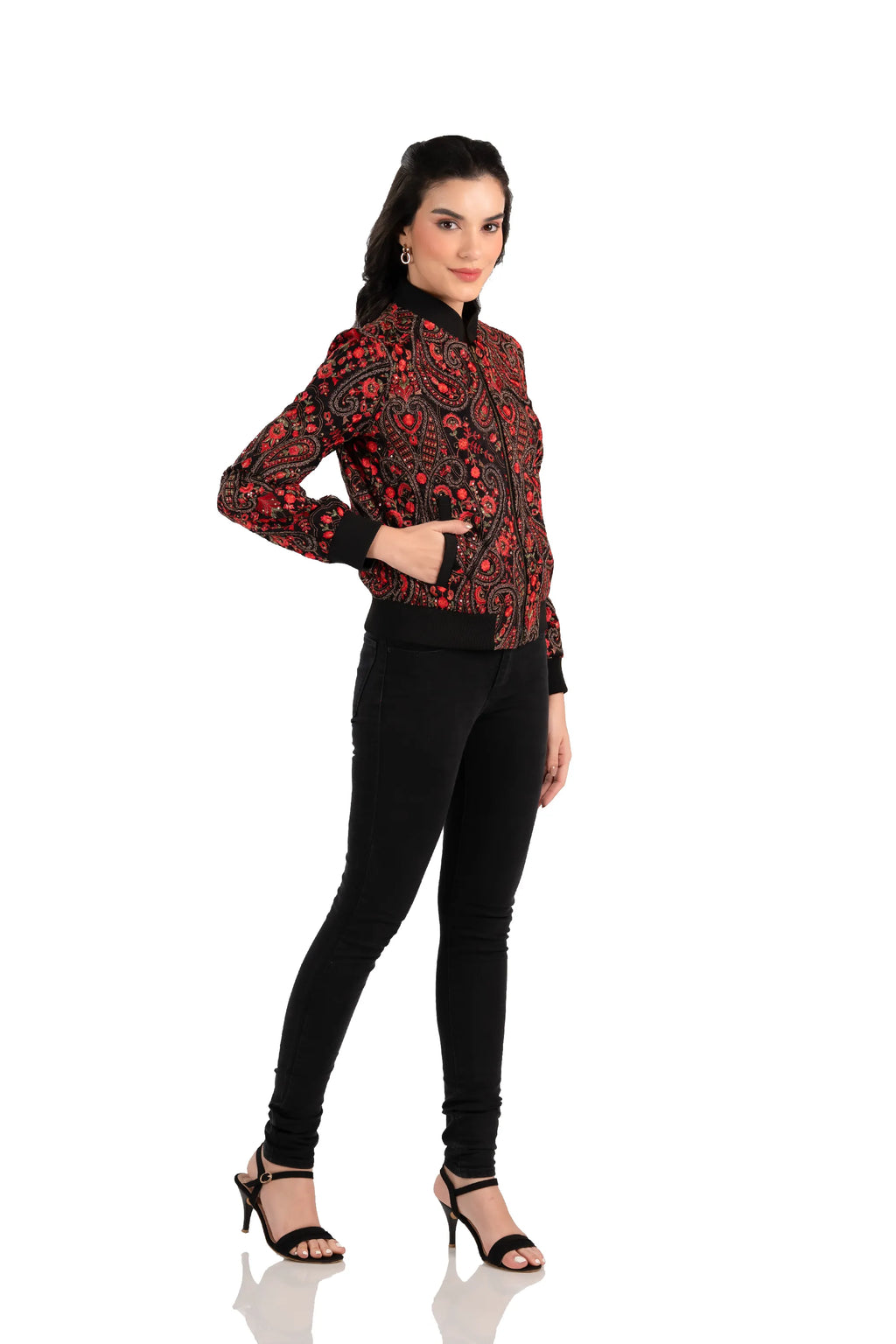 Woman in red paisley embroidered black bomber jacket, side view with pockets