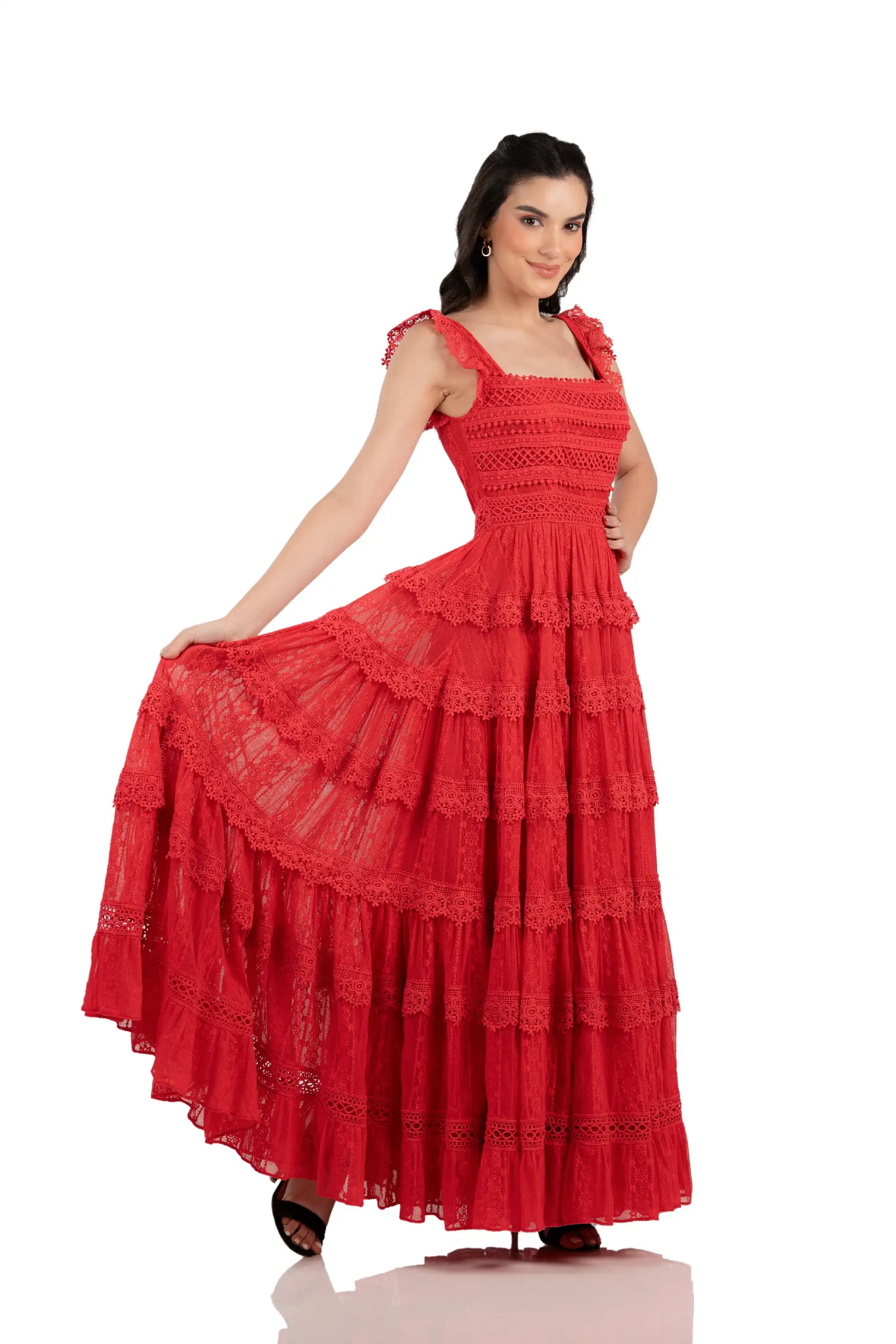 Women’s red tiered lace maxi dress with flowing skirt, model holding hem.