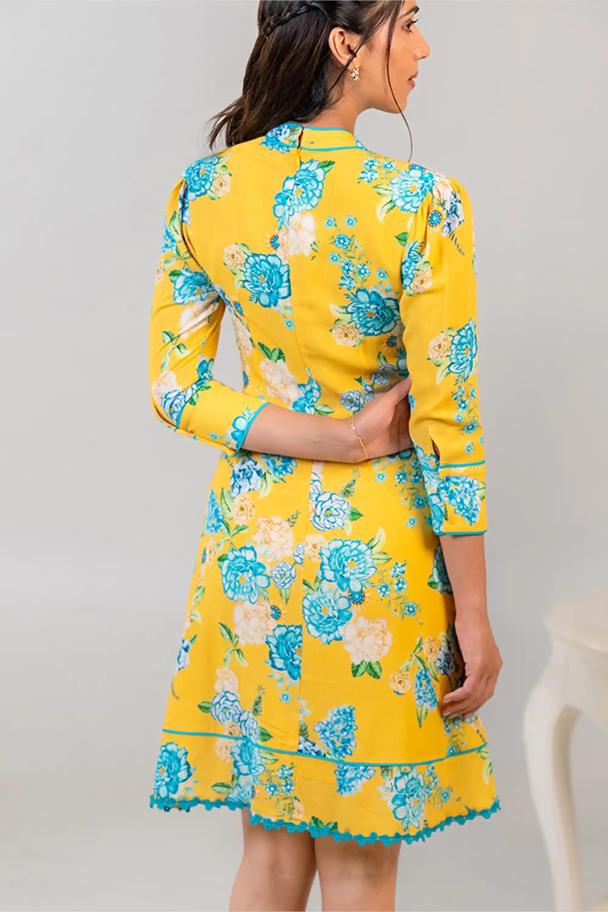 Back view of yellow floral bow tie short dress