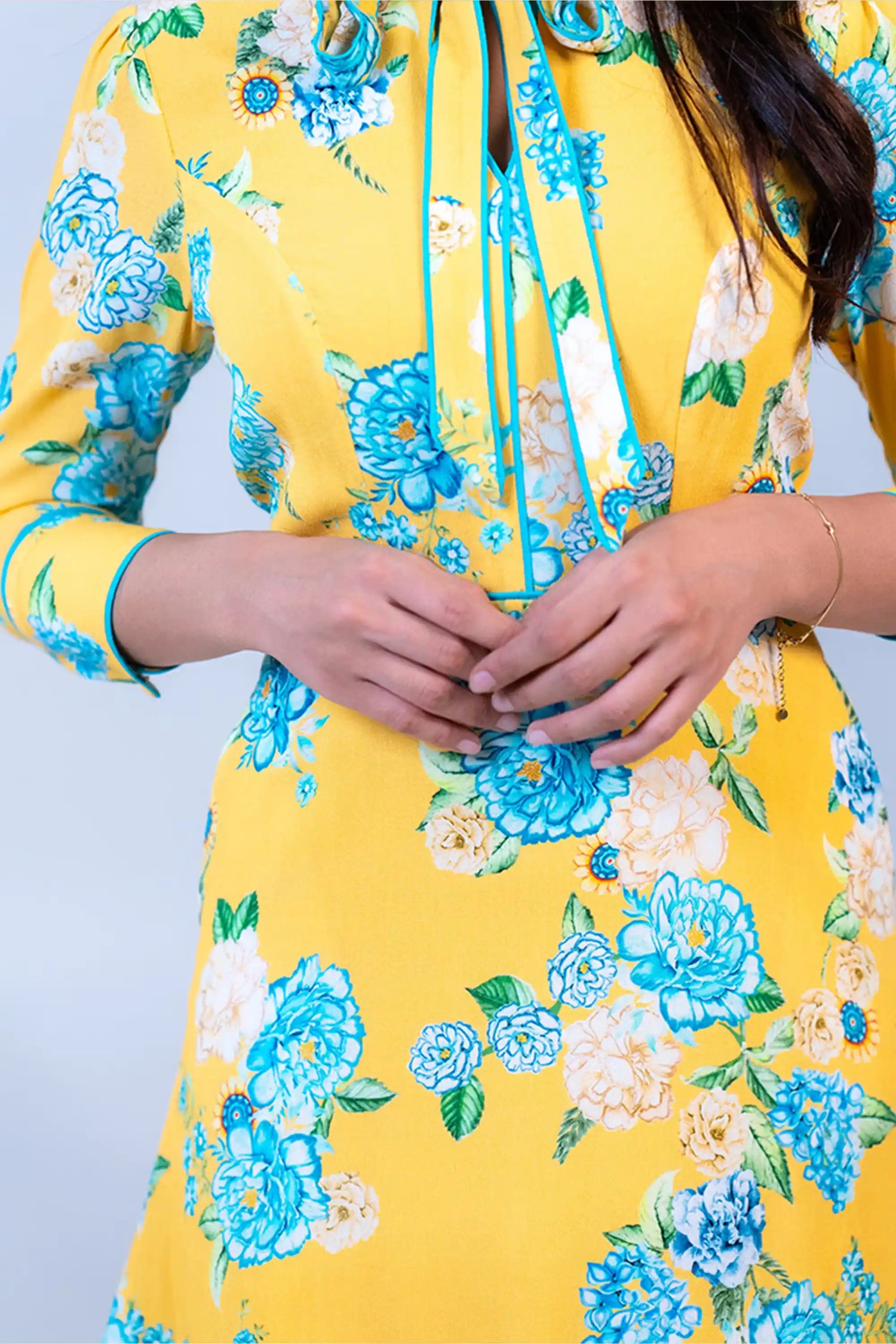 Sleeve detail of yellow floral bow tie short dress