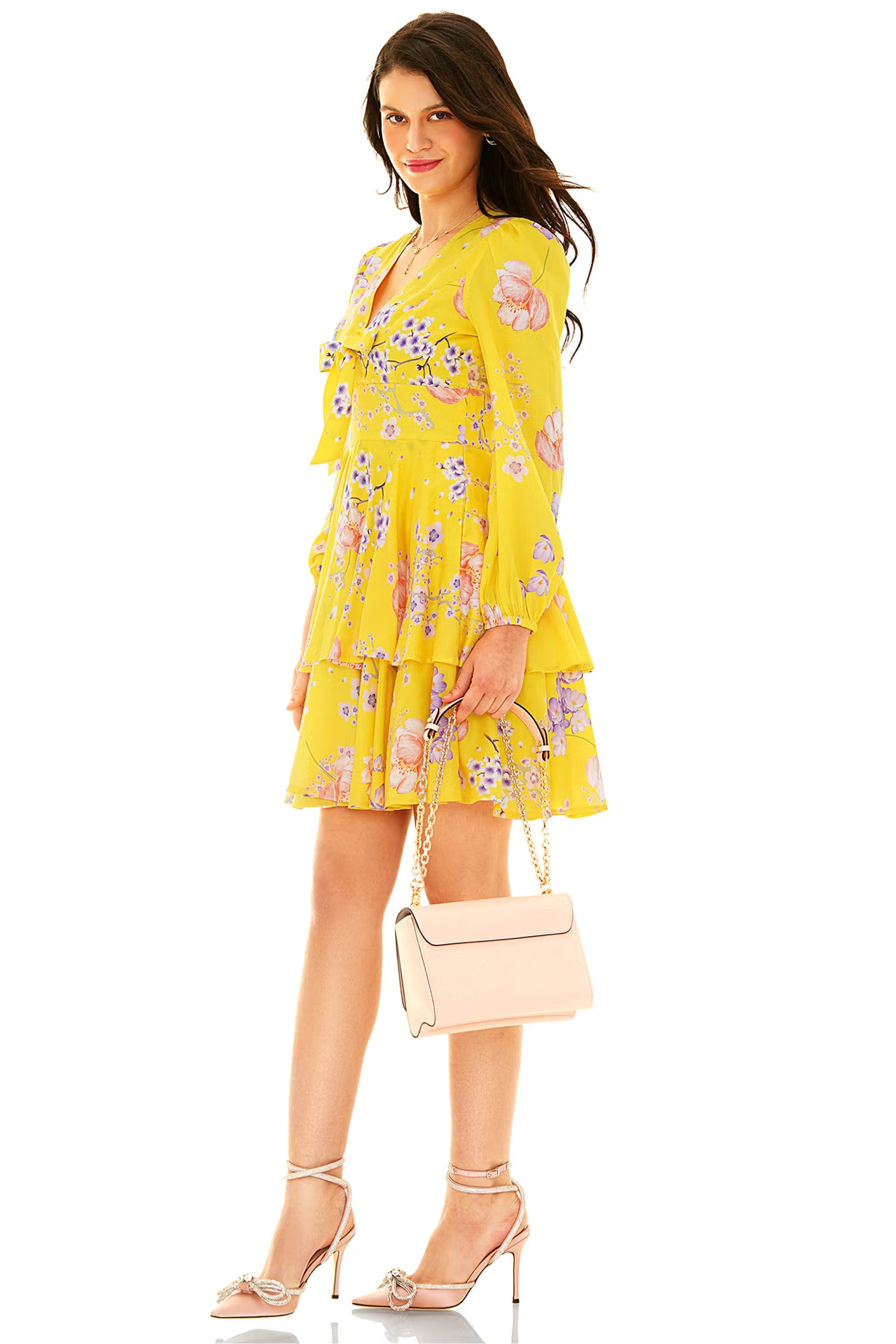 Yellow floral tiered mini dress with long sleeves and bow detail side view