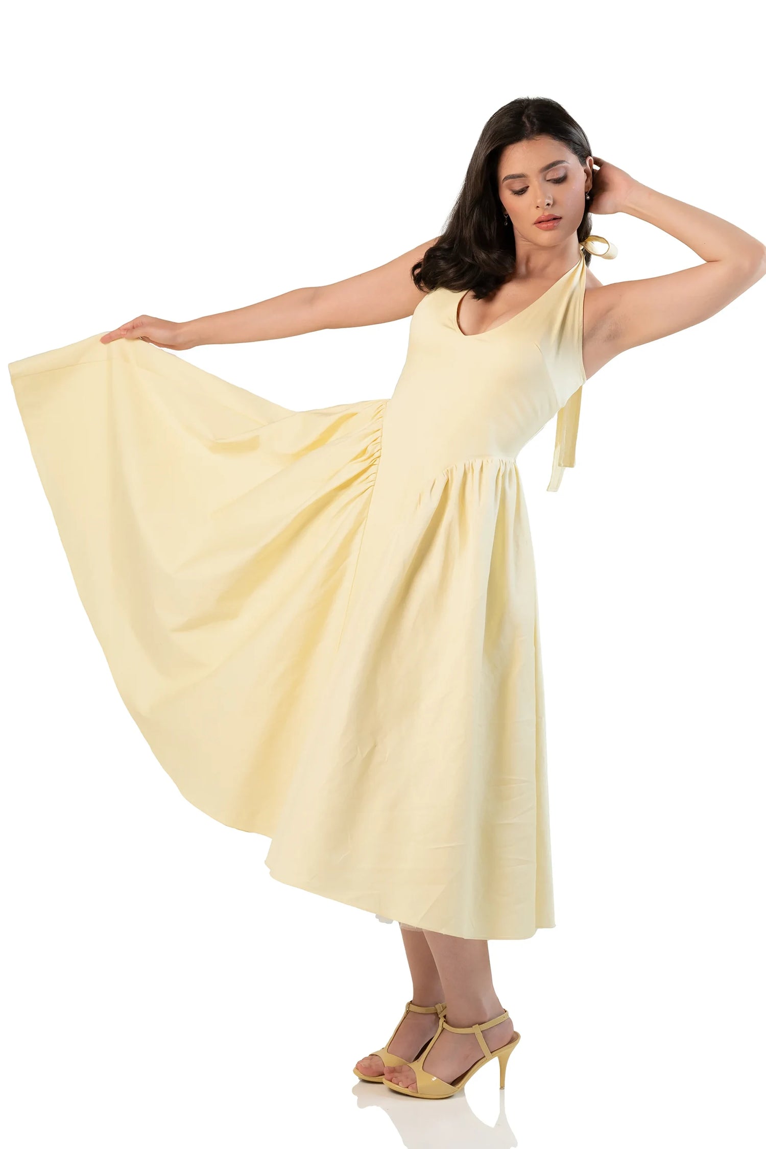 Twirl view: yellow halter midi dress with flowing flared skirt