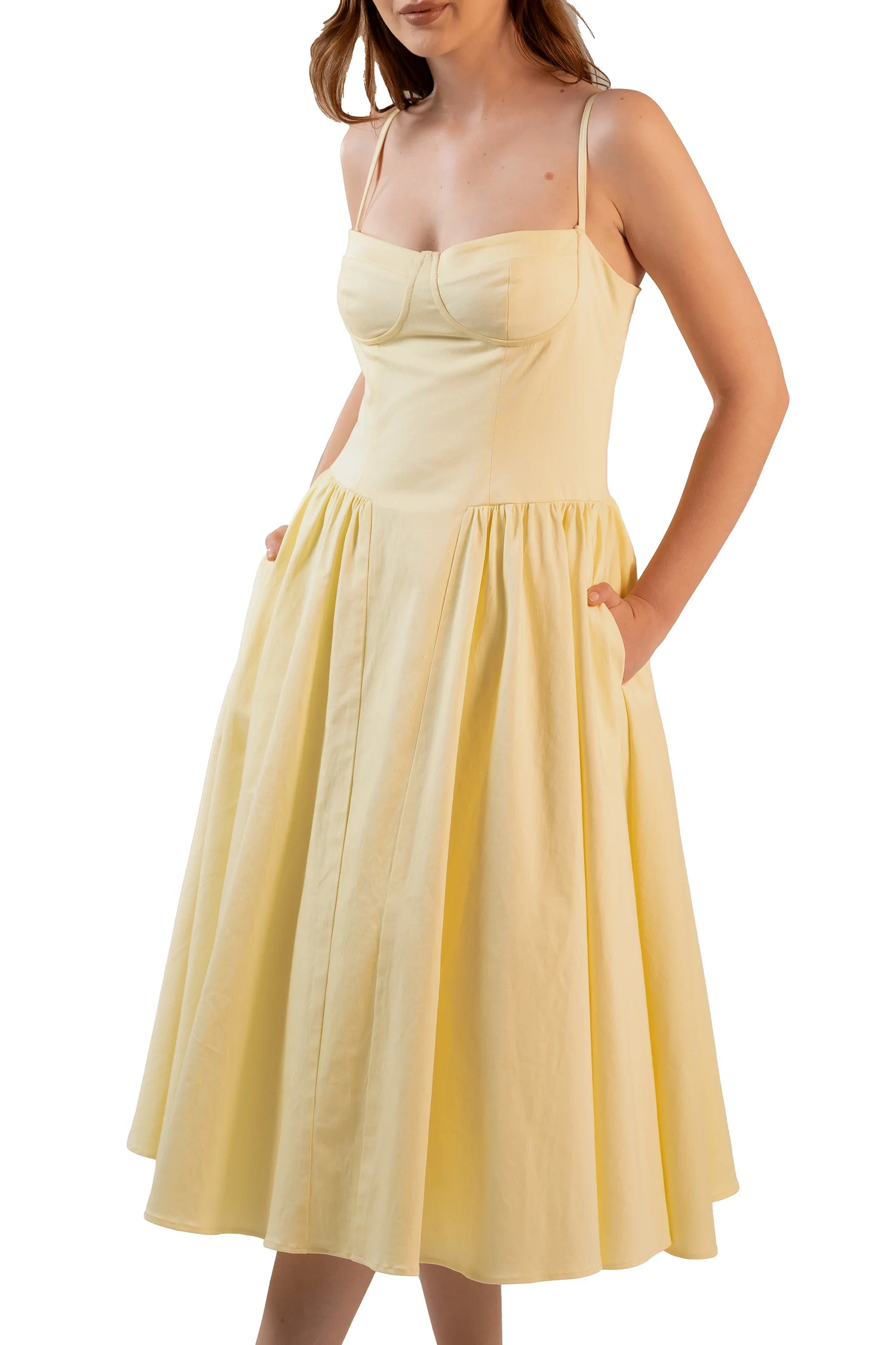 Closeup front of yellow midi dress with fitted bust and side pockets