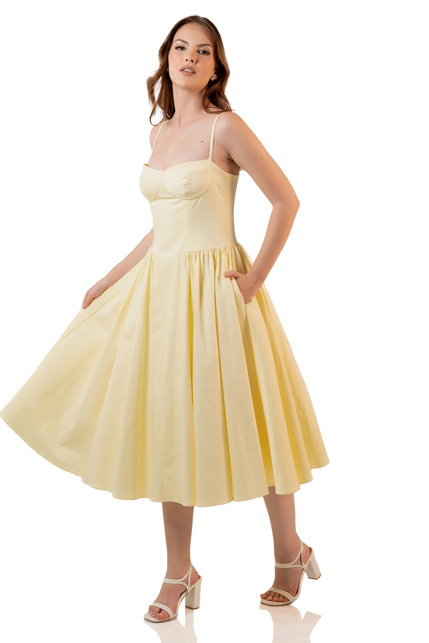 Side view of yellow midi dress with flared hem and pockets
