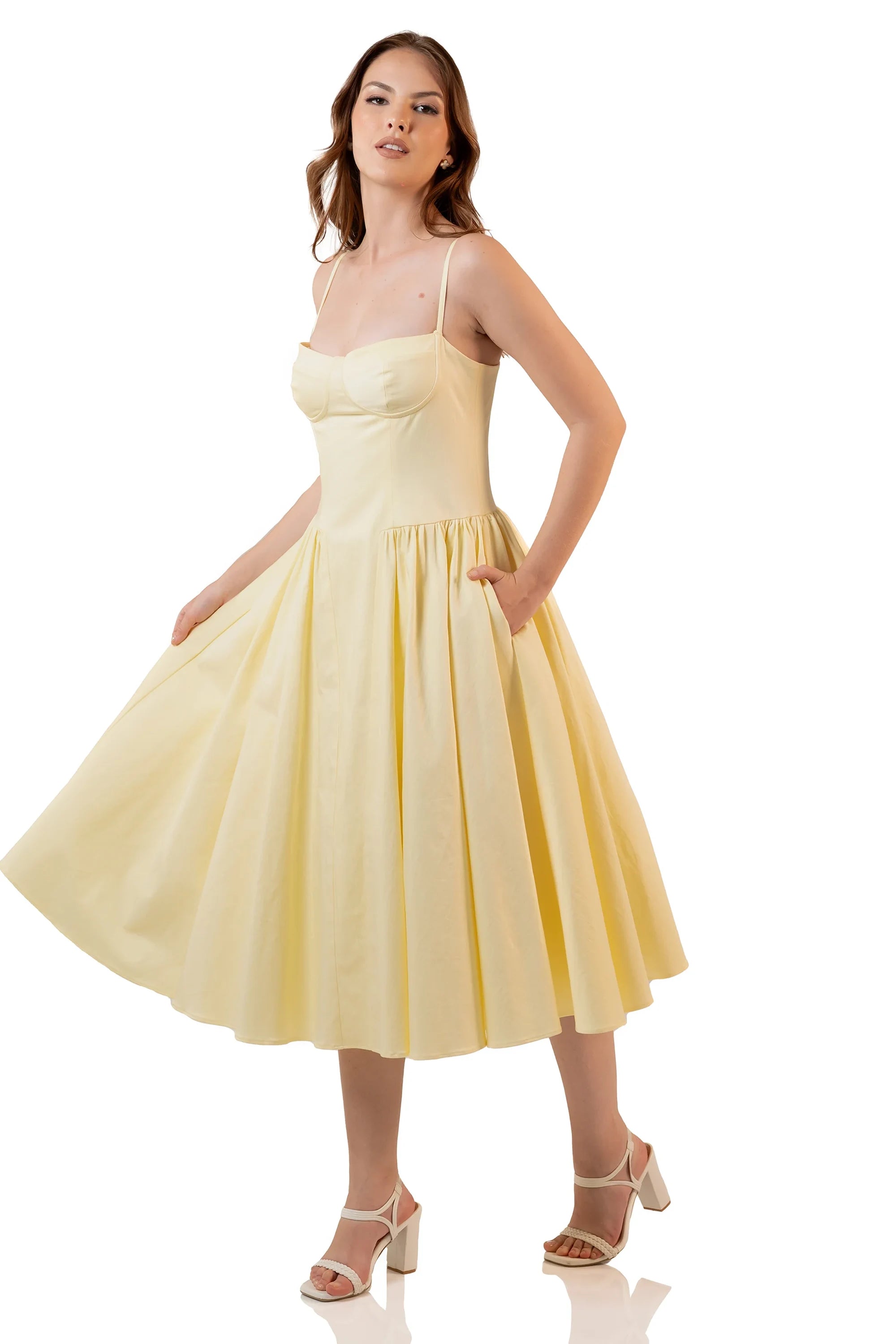 Side view of yellow midi dress with flared hem and pockets